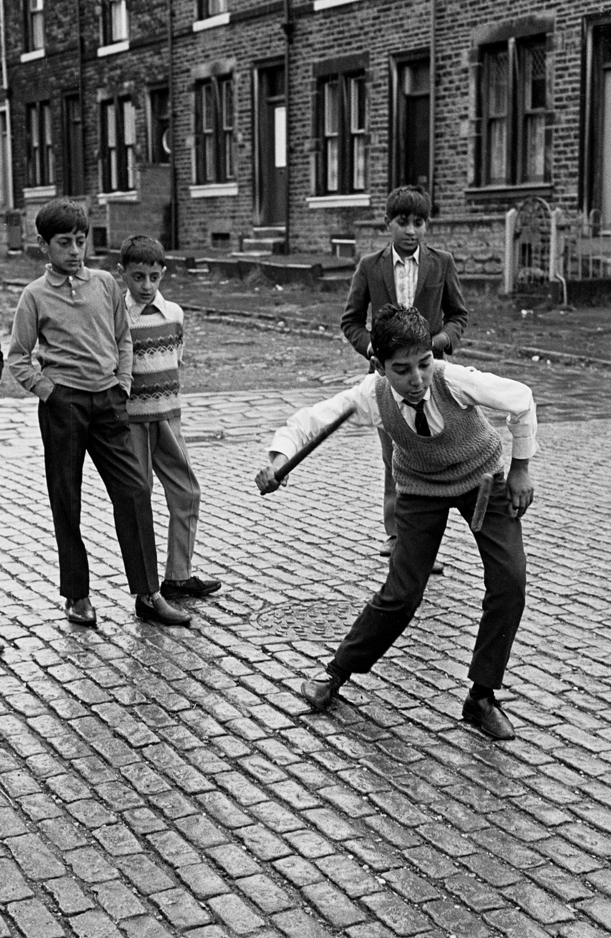 A group of children play on the cobbled streets near their homes on a Bradford estate