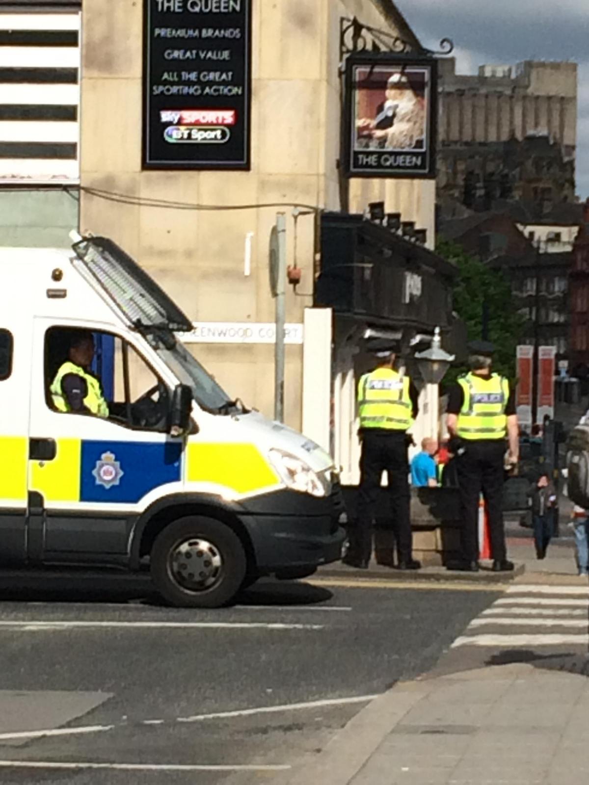 Police gather outside the Queen pub just before 10am today