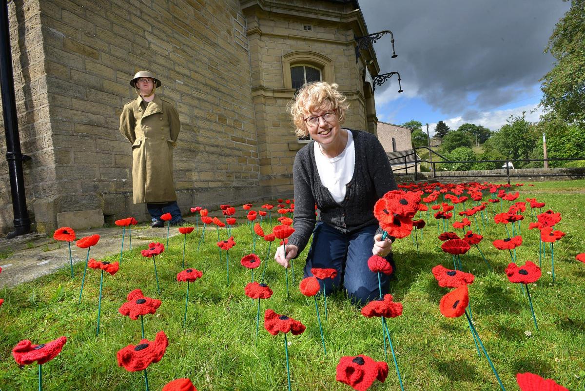 Wilsden Trinity Church has a lawn of hand-knitted poppies to commemorate the Battle of the Somme.  Andrew Bartle, pictured left, and Jane Callaghan