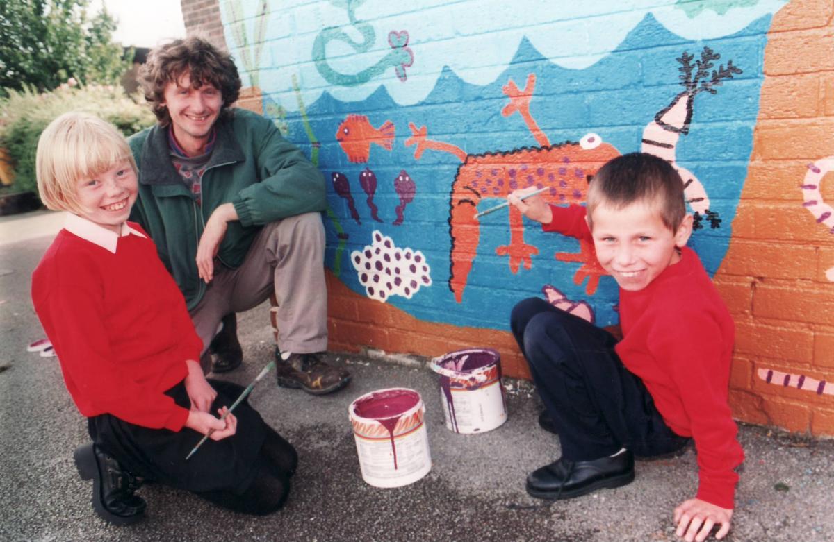 Pupils painting a mural in 1997