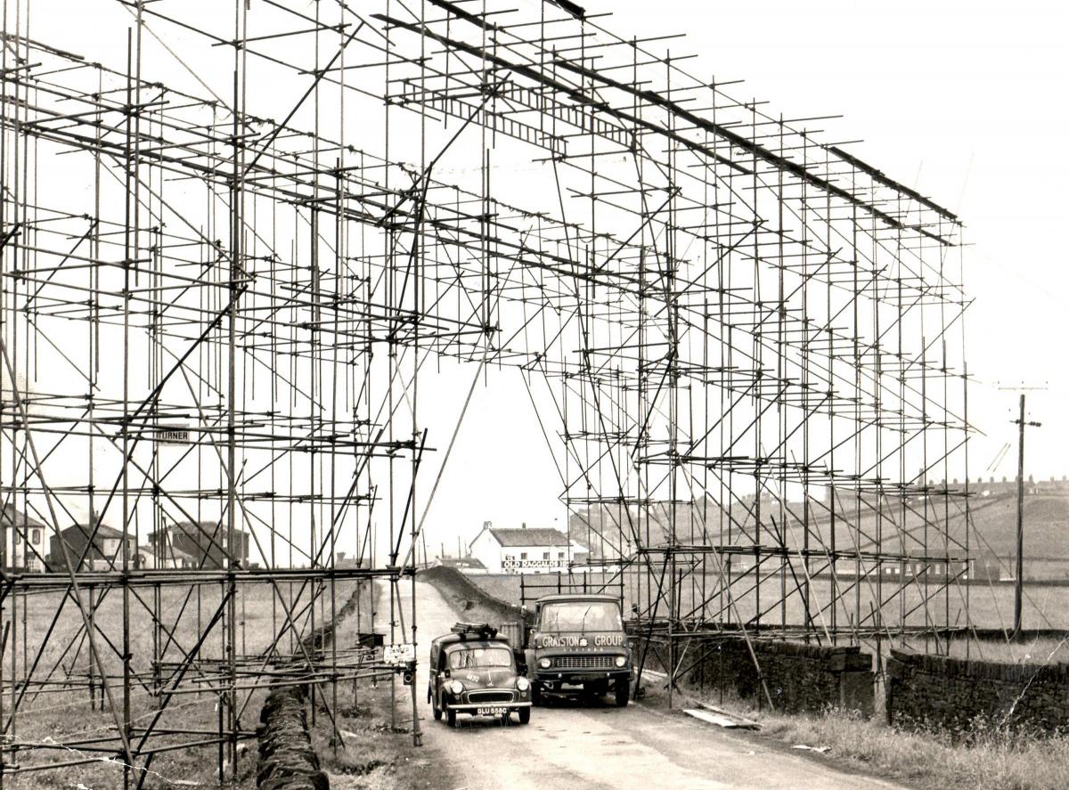 Queensbury scaffolding over Perseverance Road while electricity pylons are going up in 1969