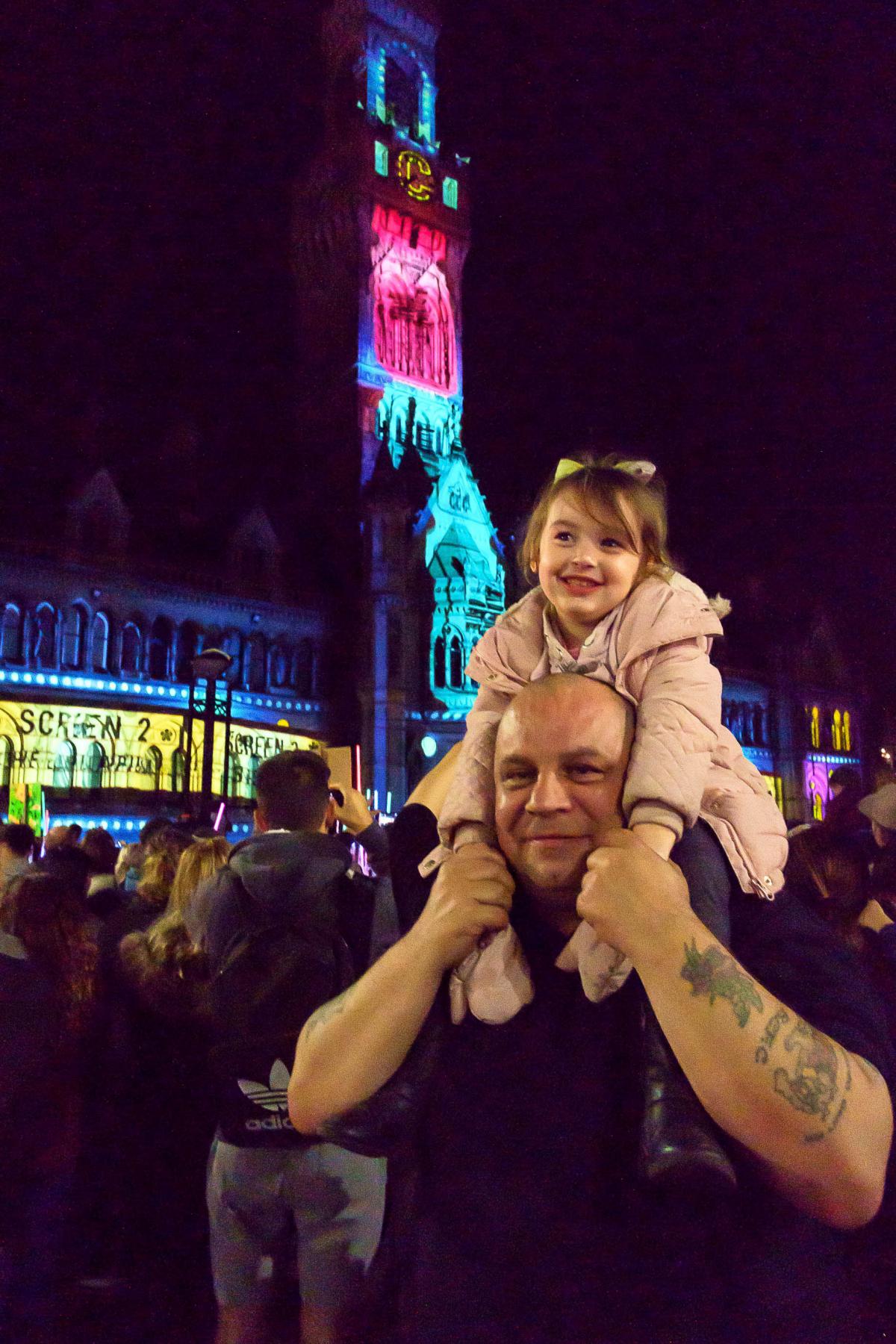 Leila Golden, 4, gets a great view of the lightshow outside City Hall