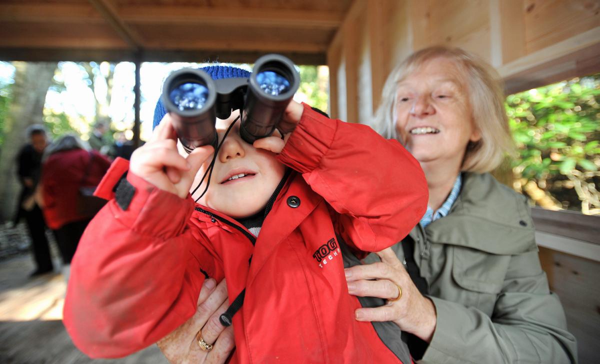 Getting to grips with the binoculars is Edward Hart helped by grandma Susan Hart