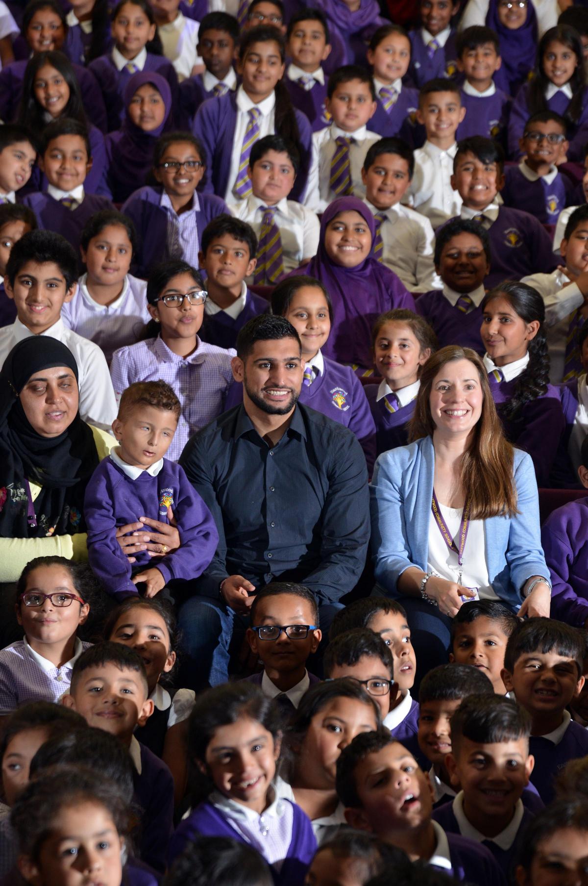 JULY Boxer Amir Khan with Pupils from Eastwood Community Primary School in Keighley