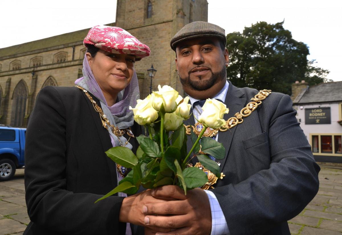 AUGUST Mayor Councillor Mohammed Nazam with his wife Shamim Akhtar hold white roses while wearing caps on Yorkshire Day