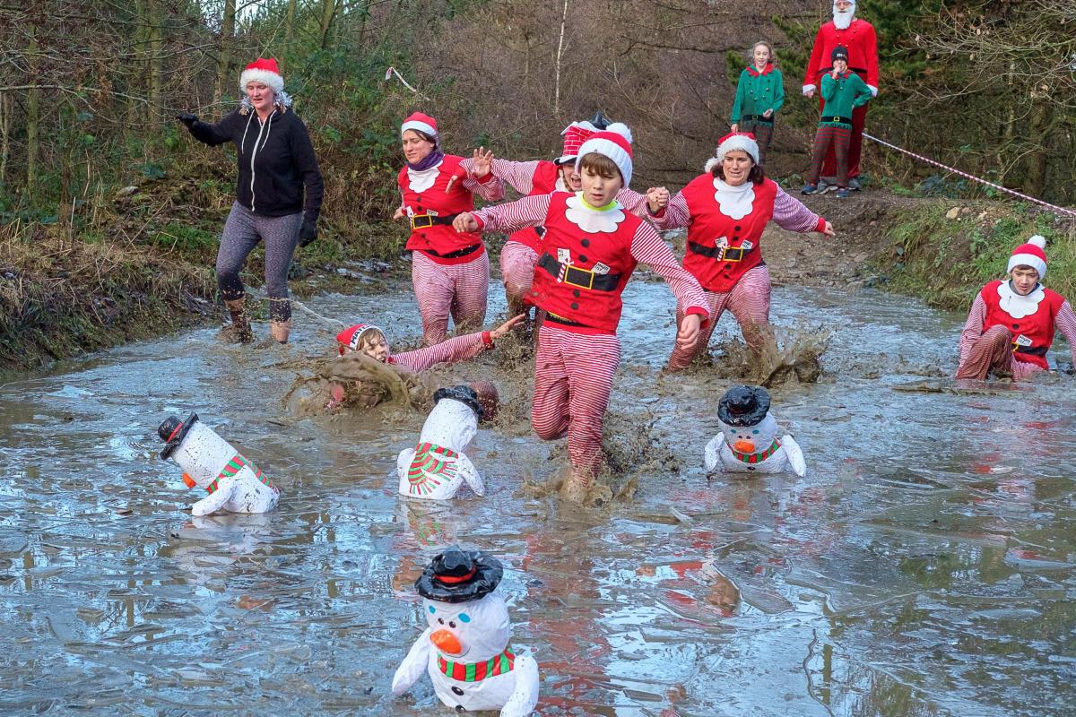 DECEMBER Participants struggle to negotiate an icy, wet and muddy section of the Santa Sludge Run