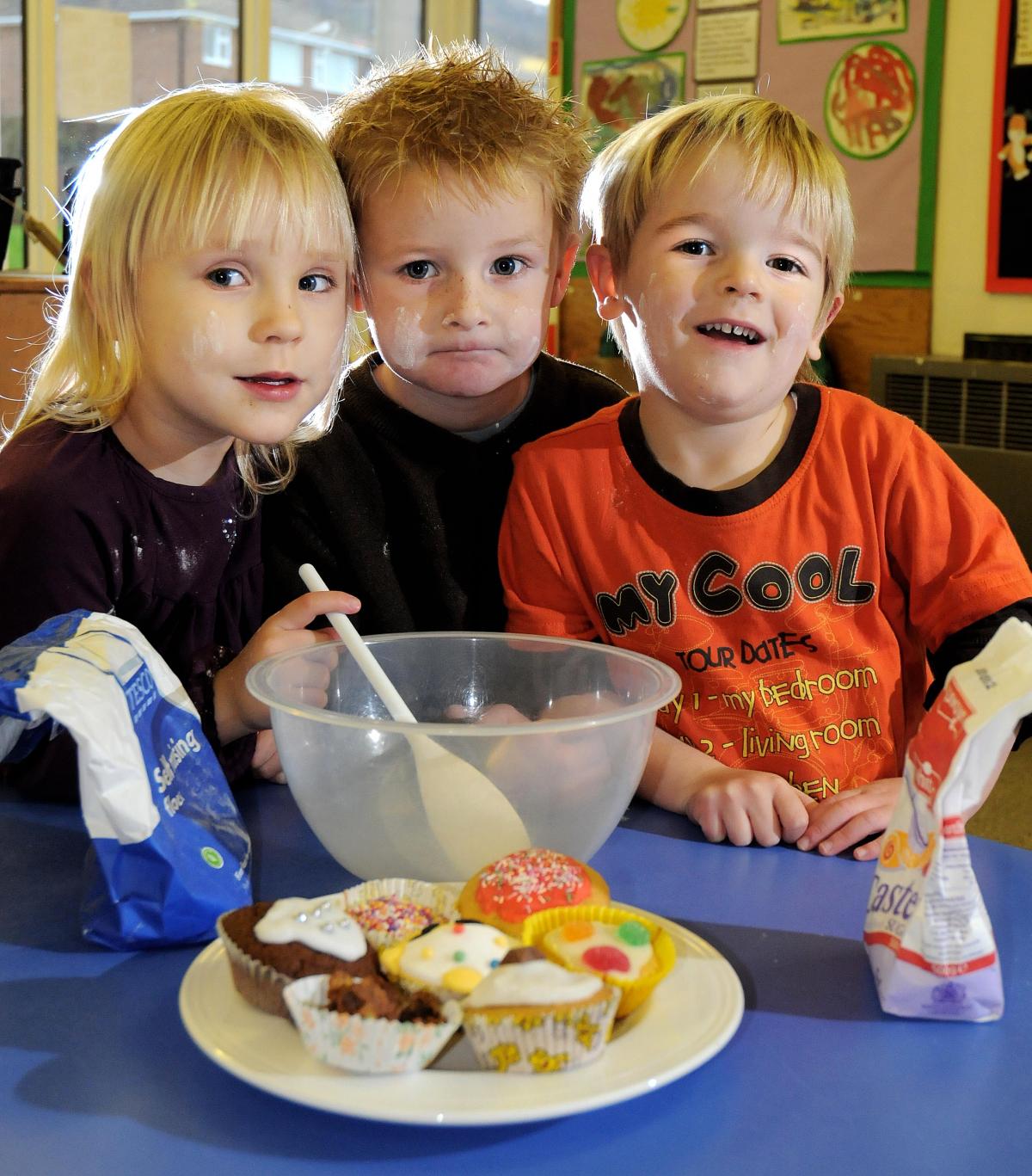 Isobel Stringer, three, Shamus Webster, four, and William Dudley, three, were among pupils who baked buns at All Saints Primary School, otley, in aid