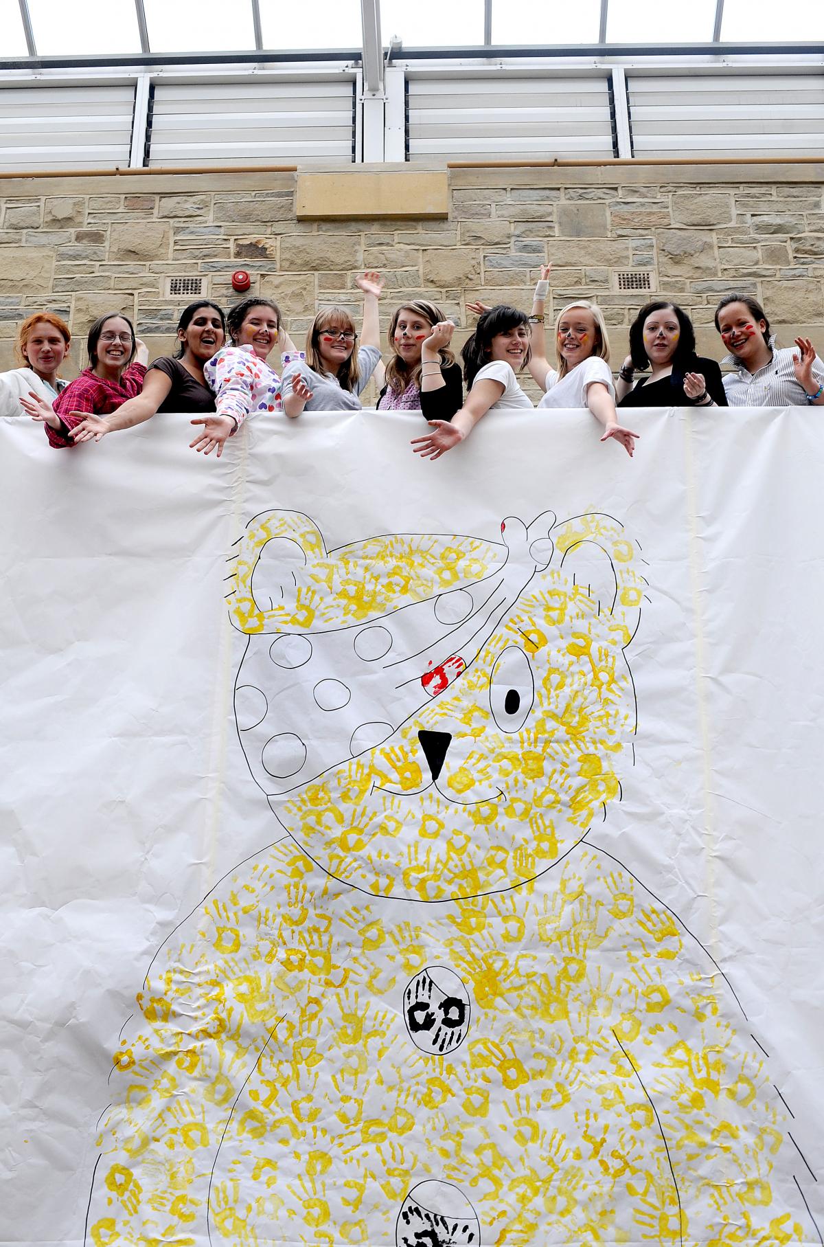 Pupils at The Girls Grammar School, Bradford, donned pyjamas to paint a giant picture of Pudsey Bear with their hands