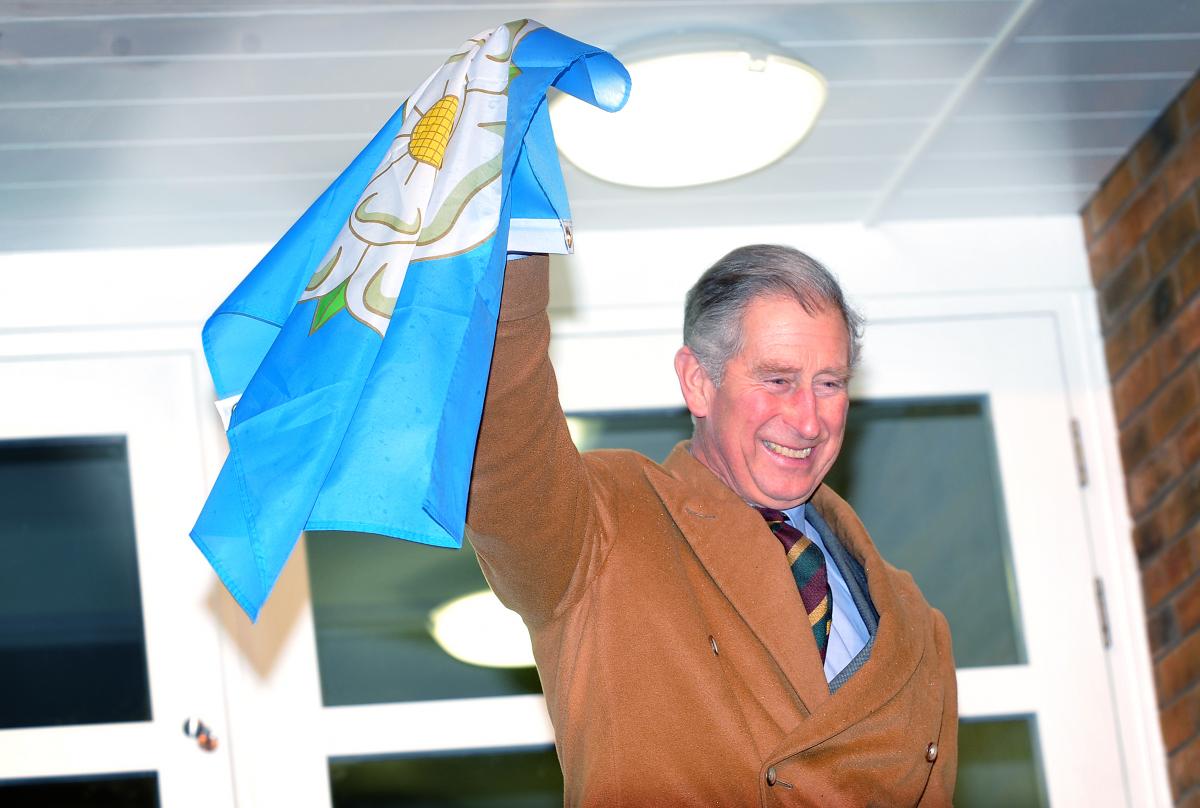 Prince Charles waves a Yorkshire flag after officially opening the Cornerstone Centre at Cottingley