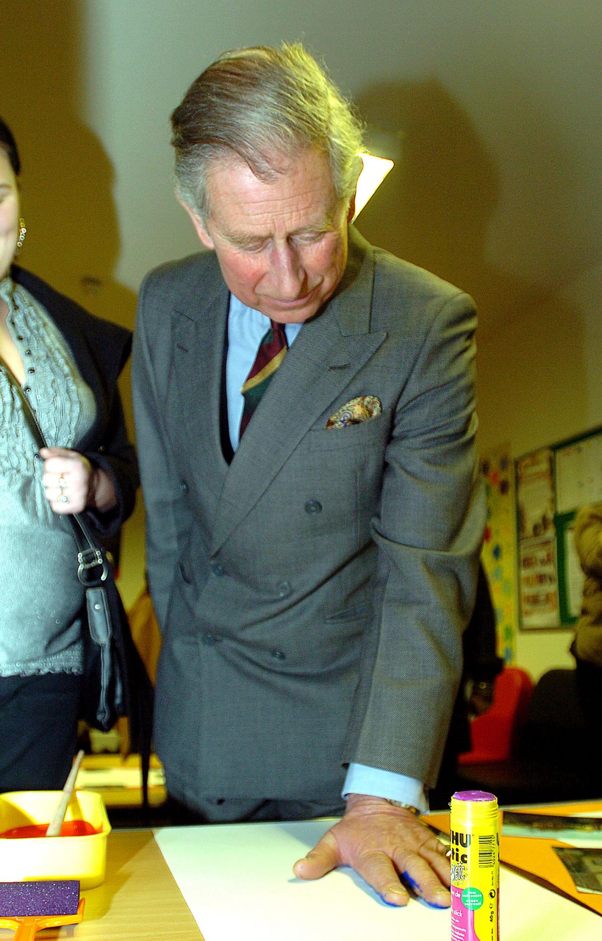Prince Charles does a hand print for the Cornerstone Centre wall