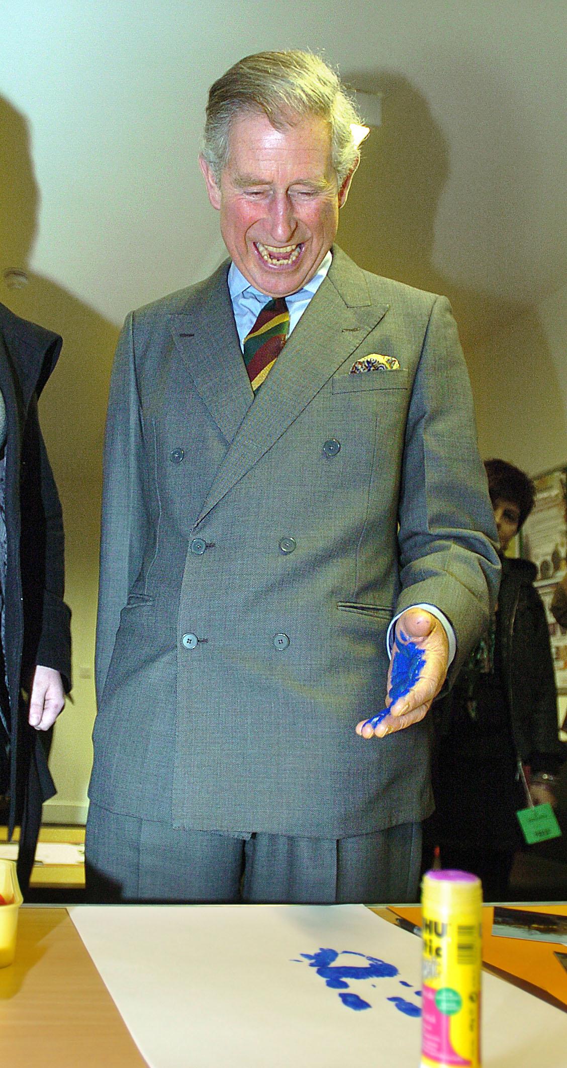 Prince Charles does a hand print for the Cornerstone Centre wall