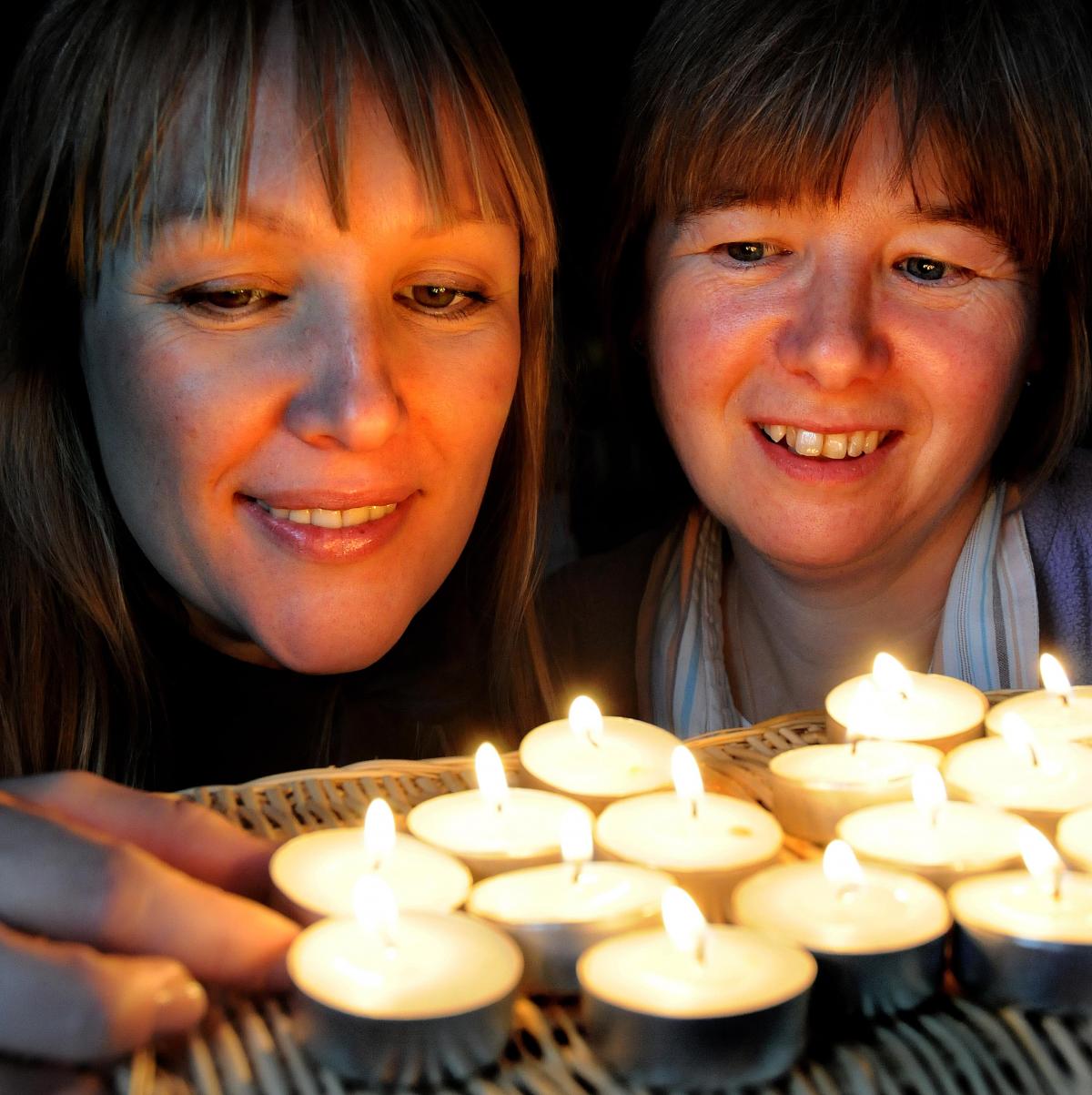 Rachel Dobson and Helen Singleton light some candles at Christchurch