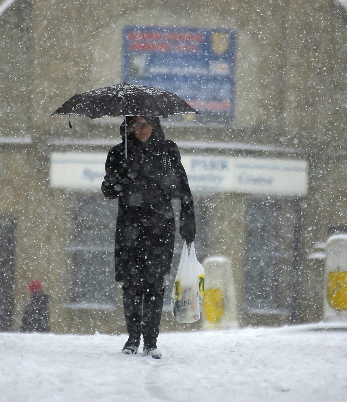 A pedestrian braves the snow.