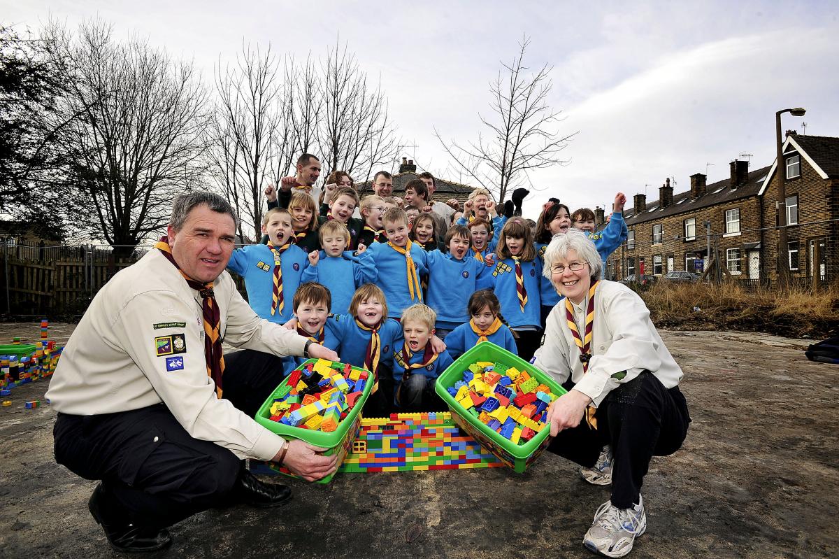 A Scout group has sent a rallying call to the community to raise money towards the £240,000 cost of rebuilding their fire-ravaged Scout hut. Leaders Chris Boardman and Joy Smith are pictured with the youngsters.