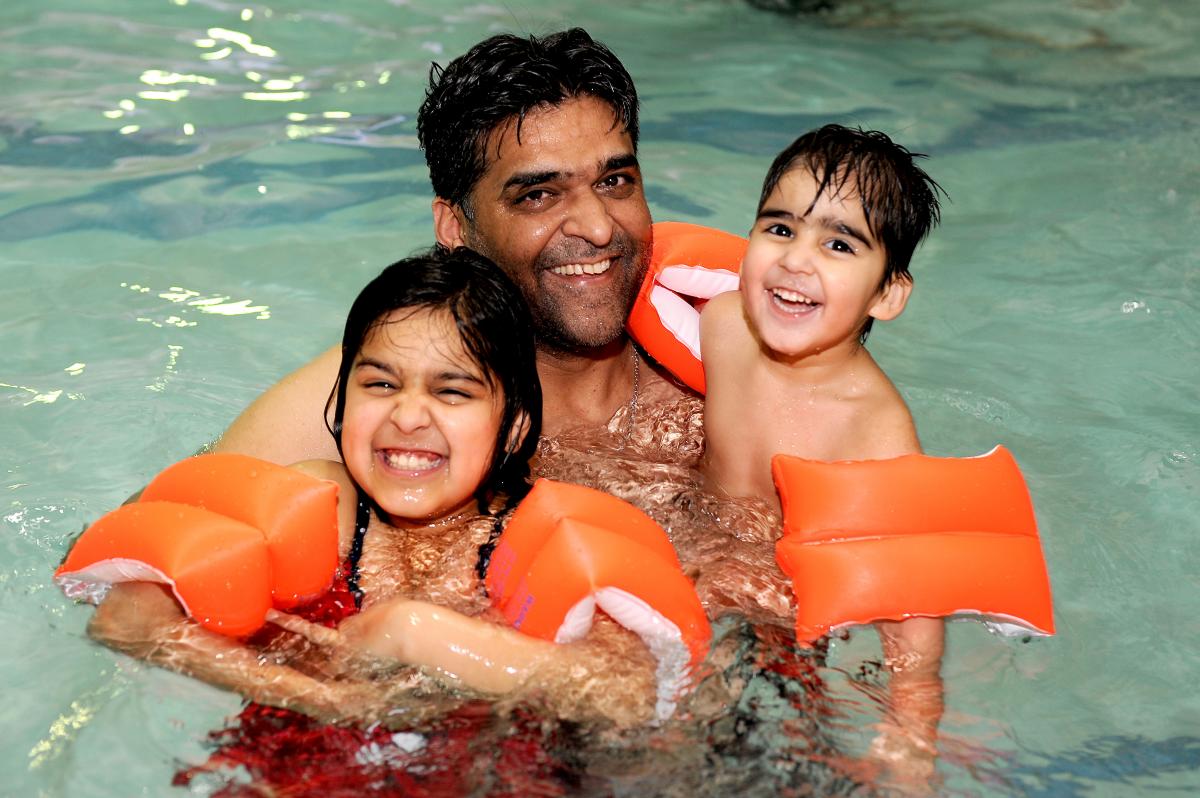 Youngsters at Richard Dunn Sports Centre have been taking advantage of a £1 swim offer during half-term. Nadeem Malik is pictured swimming with children Sana, seven, and Ahmed, two 
