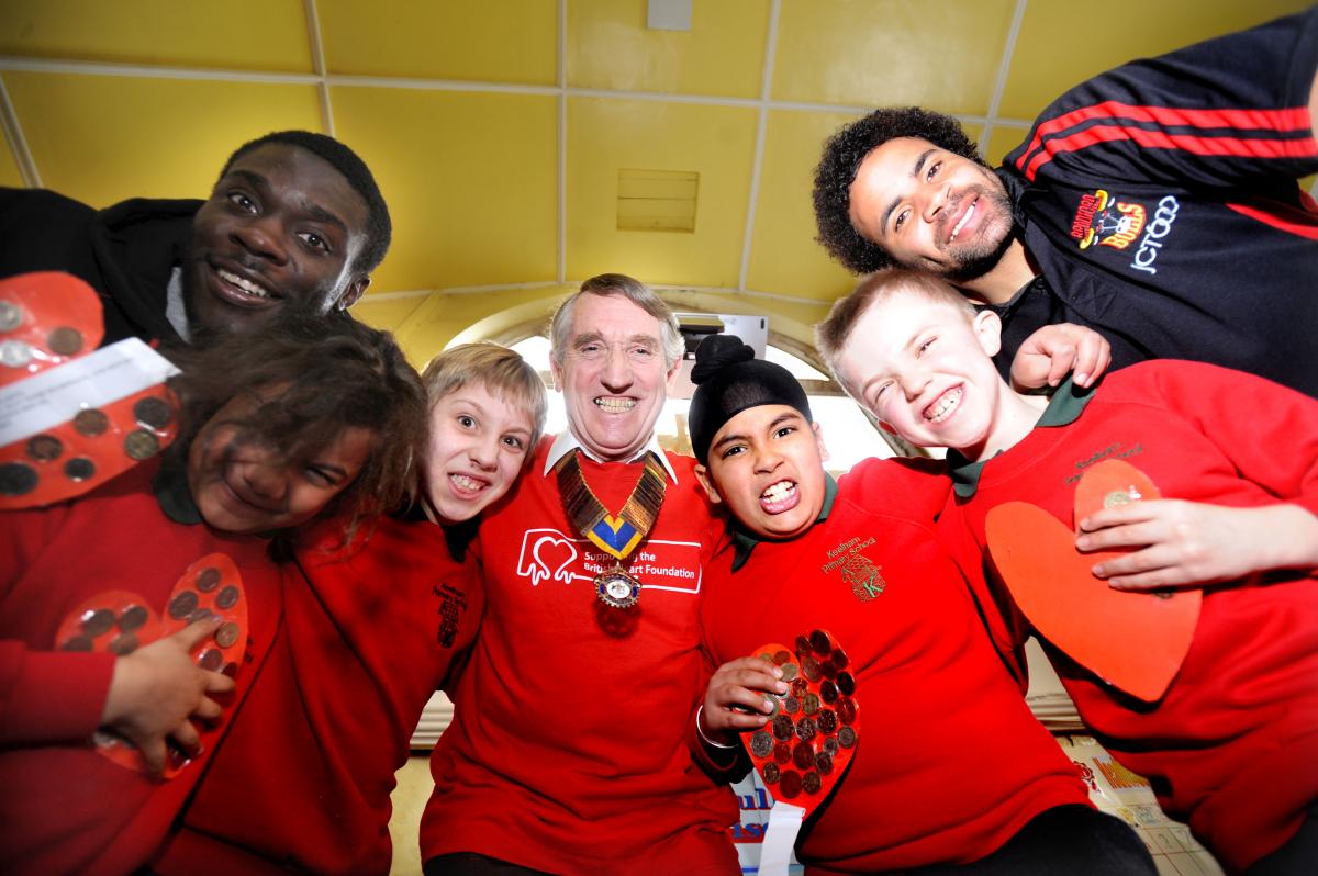 Pupils at a Bradford primary will be painting the school red this week as they support the British Heart Foundation’s Go Red Campaign. The pupils are pictured with heart attack survivor Tony Caunt and Bradford Bulls players Mike Worrincy and Rikki Sheri