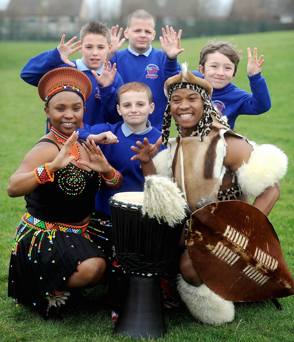 African dancers dressed in traditional Zulu outfits have entertained pupils at St Columba’s Catholic Primary School.
The group, which goes by the name of the Mighty Zulu Nation Theatre Company, originate from the Kingdom of KwaZulu Natal. 
Pictured wi