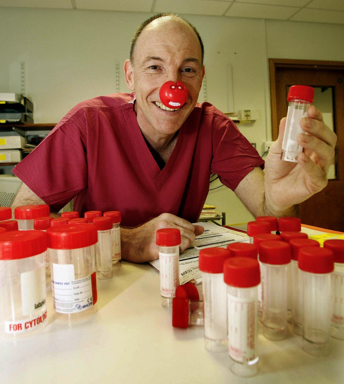 Airedale NHS Trust chief executive Adam Cairns prepares sample bottles in the the hospital's endoscopy department as part of his Red Nose Day challenge.