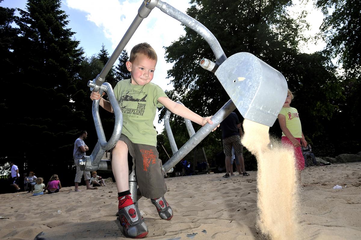 Six-year-old Marcus Coombes tries his hand at using a sand digger
