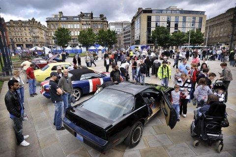 Spectators enjoy the classic cars in Centenary Square.