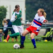 Millie West (green) scored a fine goal for Bradford (Park Avenue) Ladies against Wakefield Trinity but her team still slipped to a heavy defeat Picture: Steve Biltcliffe Photography