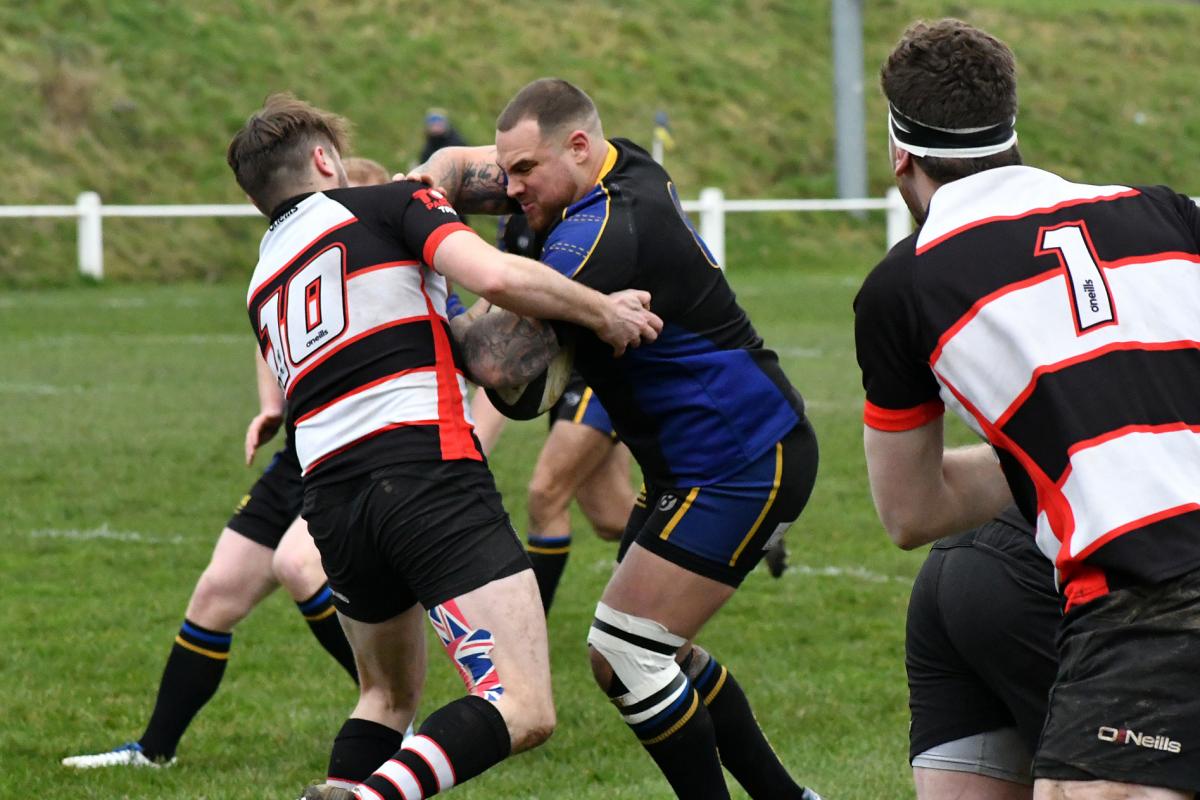 Two tries from Christian Baines (blue and black, centre) helped Salem edge out Burley in the cup final. Picture: Richard Leach.