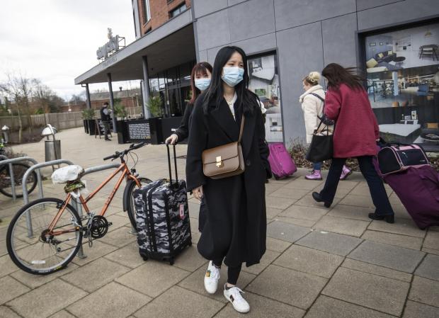 Bradford Telegraph and Argus: Two women wearing face masks leave the Staycity Hotel in the centre of York. Picture: Danny Lawson/PA Wire