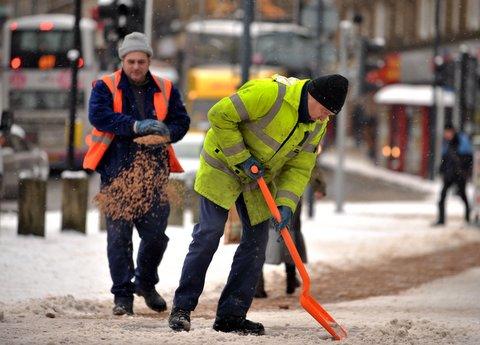 Council workers busy gritting pavements in the city centre.