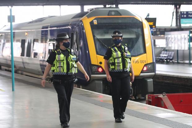 Police officers pictured here wearing face masks at Leeds railway station when face coverings become mandatory on public transport in England. Picture: PA