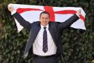 Steve McNamara flies the flag after being officially unveiled as the new England coach yesterday