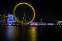 The London Eye lit yellow for Marie Curie’s National Day of Reflection. Pic: PA