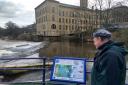 Nick Milsom, community engagement officer with the Aire Rivers Trust, looking at the new  fish pass interpretation board