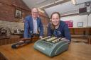 William Gaunt and Rachel Moaby with a comptometer, which was the first mechanical calculator used in the mill office, in the foreground and a crockmeter that tests the colour of the dye
