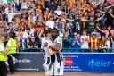 Emmanuel Osadebe consoles captain Richie Smallwood as the City fans sing on after the final whistle
