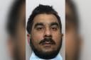 Police have issued a new image of wanted man Maqsood Ali who has Bradford links