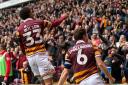 Adam Wilson and Richie Smallwood enjoy City's goal with the crowd