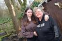 Michelle Potterton with her teenage daughter Codie, standing in front of a tree in their garden which was struck by lightning