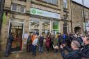 Author Adrian Tchaikovsky cutting the ribbon at the new Oxfam book shop in Skipton
