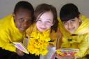 Pupils from Lapage Primary School, Barkerend Road, Bradford, took part in a world record attempt to read William Wordsworth's daffodil poem, 2004. From left: Taffy Mareyanadzo, Tanya Wood and Huma Mahmood