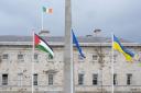 The flag of Palestine (left) flying outside Leinster House, Dublin (PA)