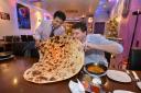 Mohammad Sadiq, owner of Omar's Balti House, with T&A  reporter Mark Stanford as he attempted the giant naan challenge