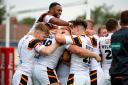 Bulls winger Omari Caro is mobbed by team-mates after completing his hat-trick of tries in the victory at Sheffield – Picture: Simon Davies