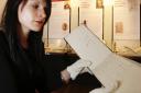 HISTORIC: Library and collections officer Sarah Laycock holds Anne Bronte’s songbook from the Bronte Relics exhibition