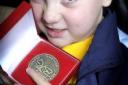Finley Racey clutches the medal he won at the Transplant Games