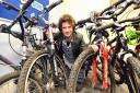 HARD AT WORK: Colin Boyle with some of the restored bikes which can make a difference to people’s lives
