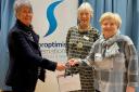 Left to right: Kath Tarpy, with President – Elect of S I Yorkshire, Sue Butler and Pauline Doyle, the Ilkley club’s contact with the refuge handing over the vouchers, cheque and other gifts