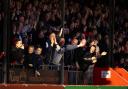 Crawley fans celebrate their team's third goal last night