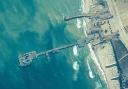 US Army soldiers assigned to the 7th Transportation Brigade (Expeditionary), US Navy sailors assigned to Amphibious Construction Battalion 1, and Israel Defence Forces placing the Trident Pier on the coast of the Gaza Strip on May 16 (US Central Command
