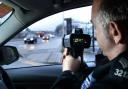 A traffic officer using a mobile speed camera