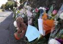 Floral tributes at the scene of the collision near Eastburn